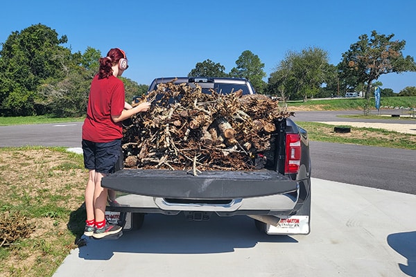 our daughter unloading firewood from the back of our truck at Colorado River Thousand Trails campground