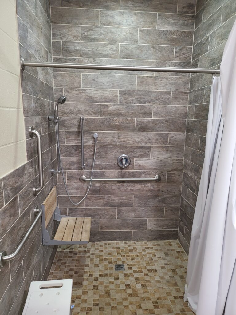 shower stall in section E with fold down seats and multiple safety rails at Colorado River Thousand Trails campground